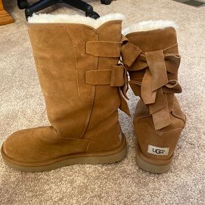 Tall light brown ugg boots with bows in the back